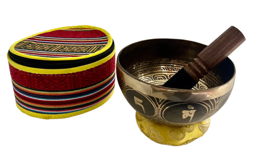 Tibetan singing bowl with wooden striker and colorful carrying case on a white background