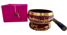 Load image into Gallery viewer, Purple singing bowl with gold accents on a white surface, next to a pink box and wooden mallet.
