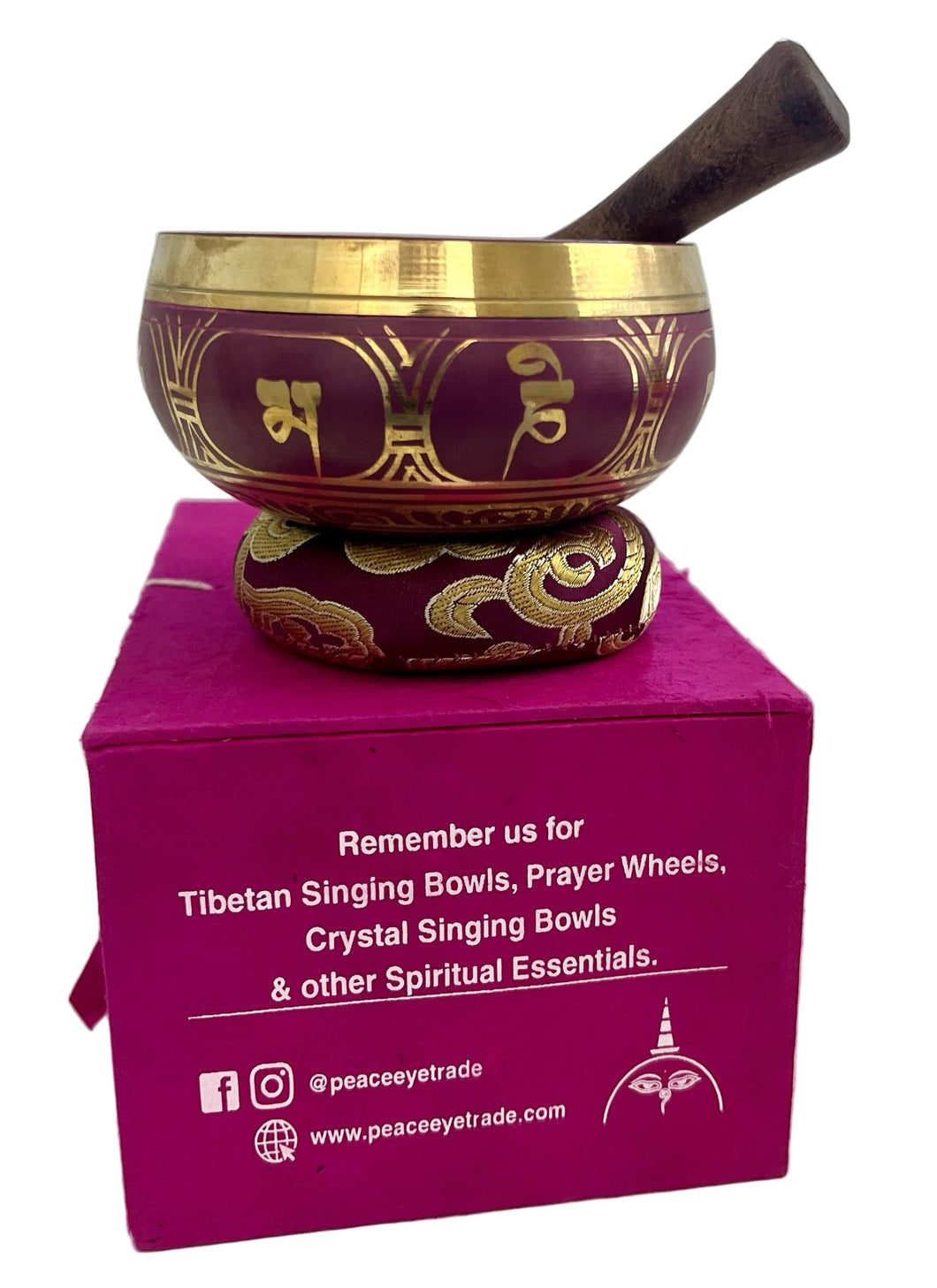 Decorative singing bowl with gold patterns on a pink box, featuring branding text.